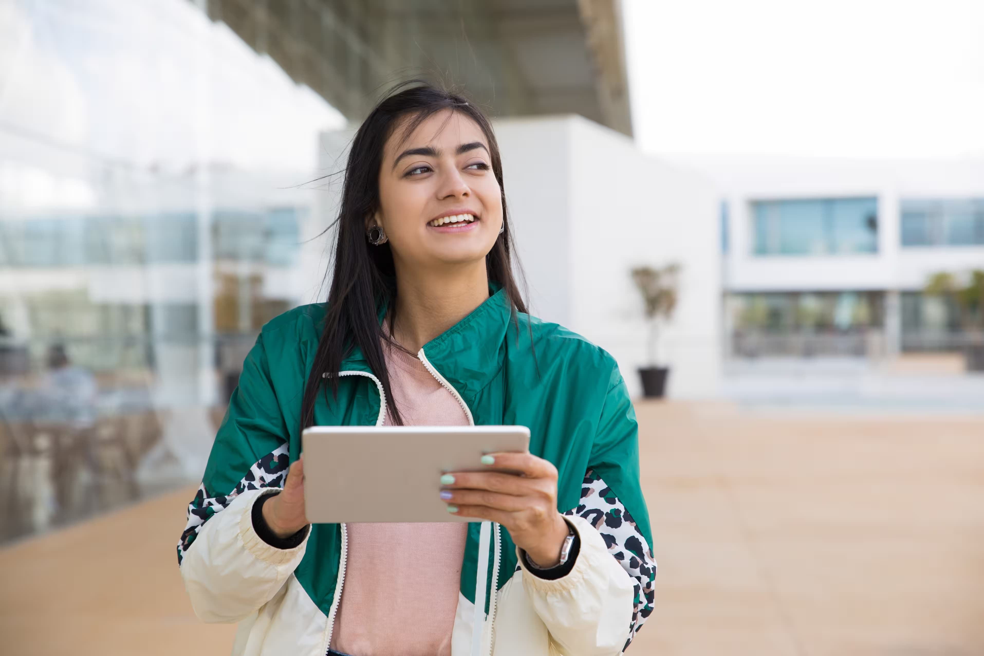 Student on campus holding a tablet